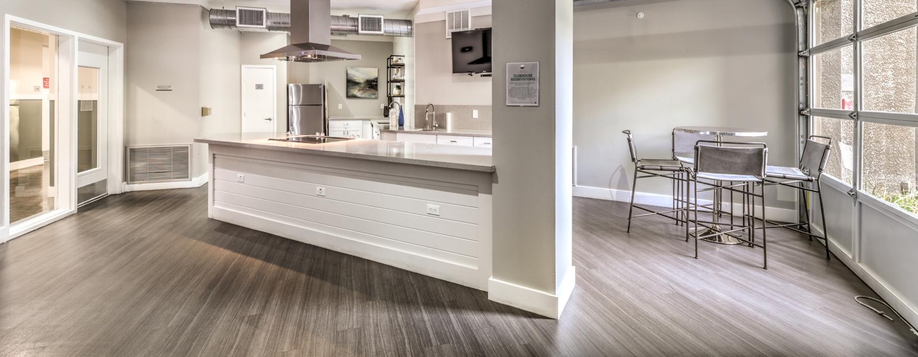 a kitchen with a bar and chairs