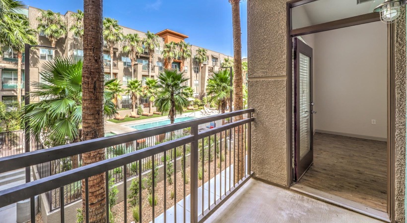 a building with palm trees and a balcony