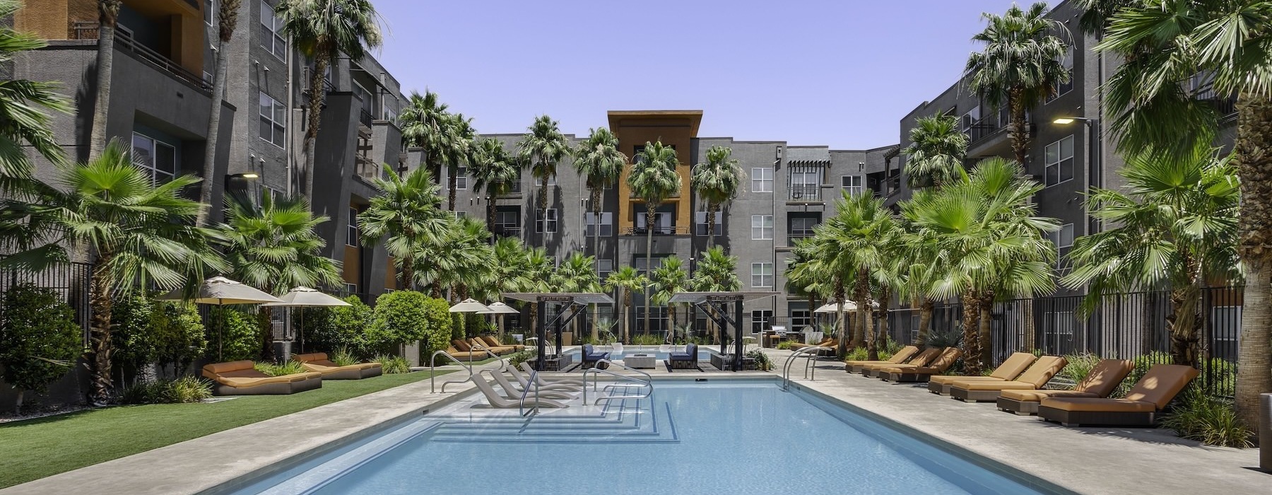 pool with lounge chairs and plants