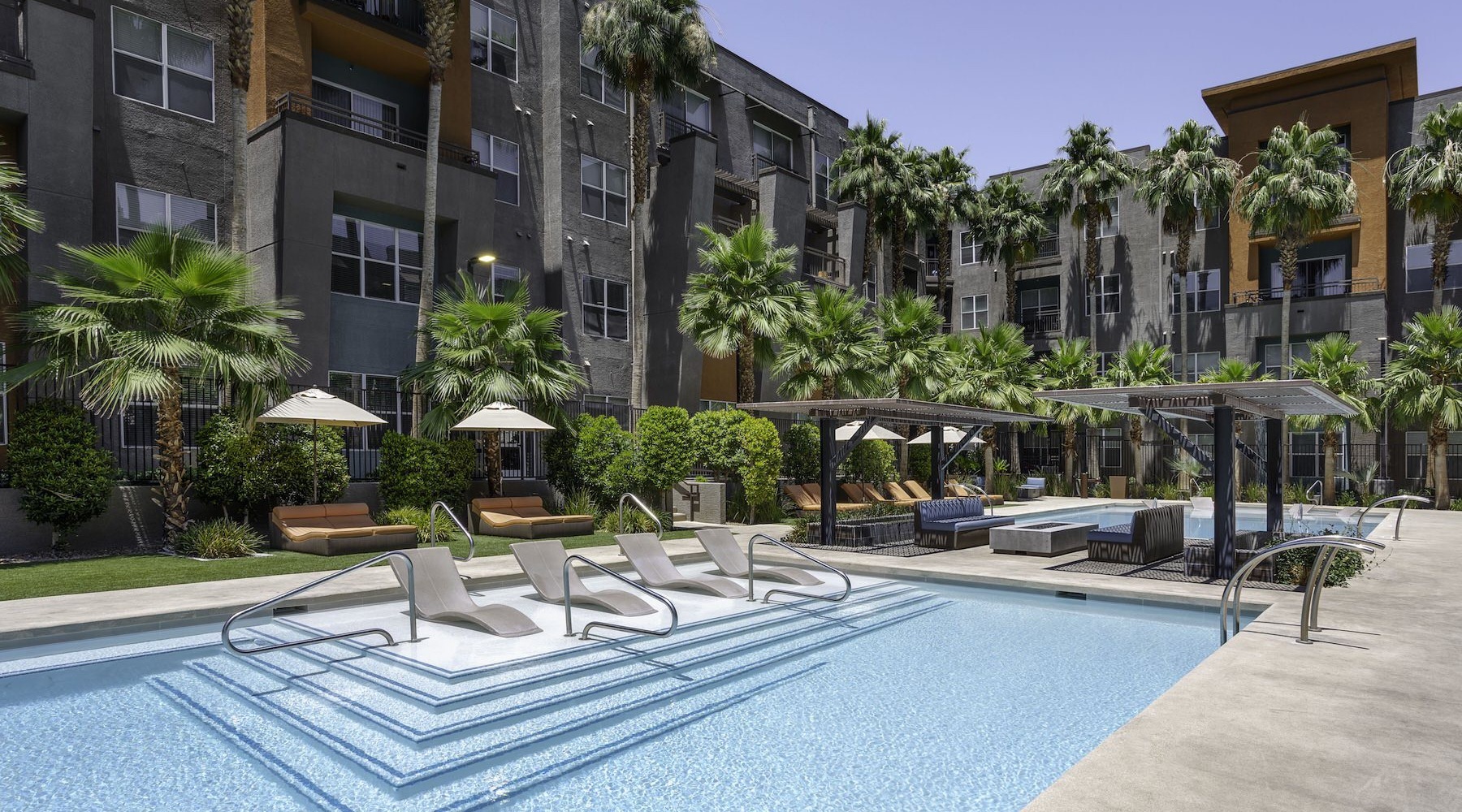 Resort-style swimming pool pool with lounge chairs